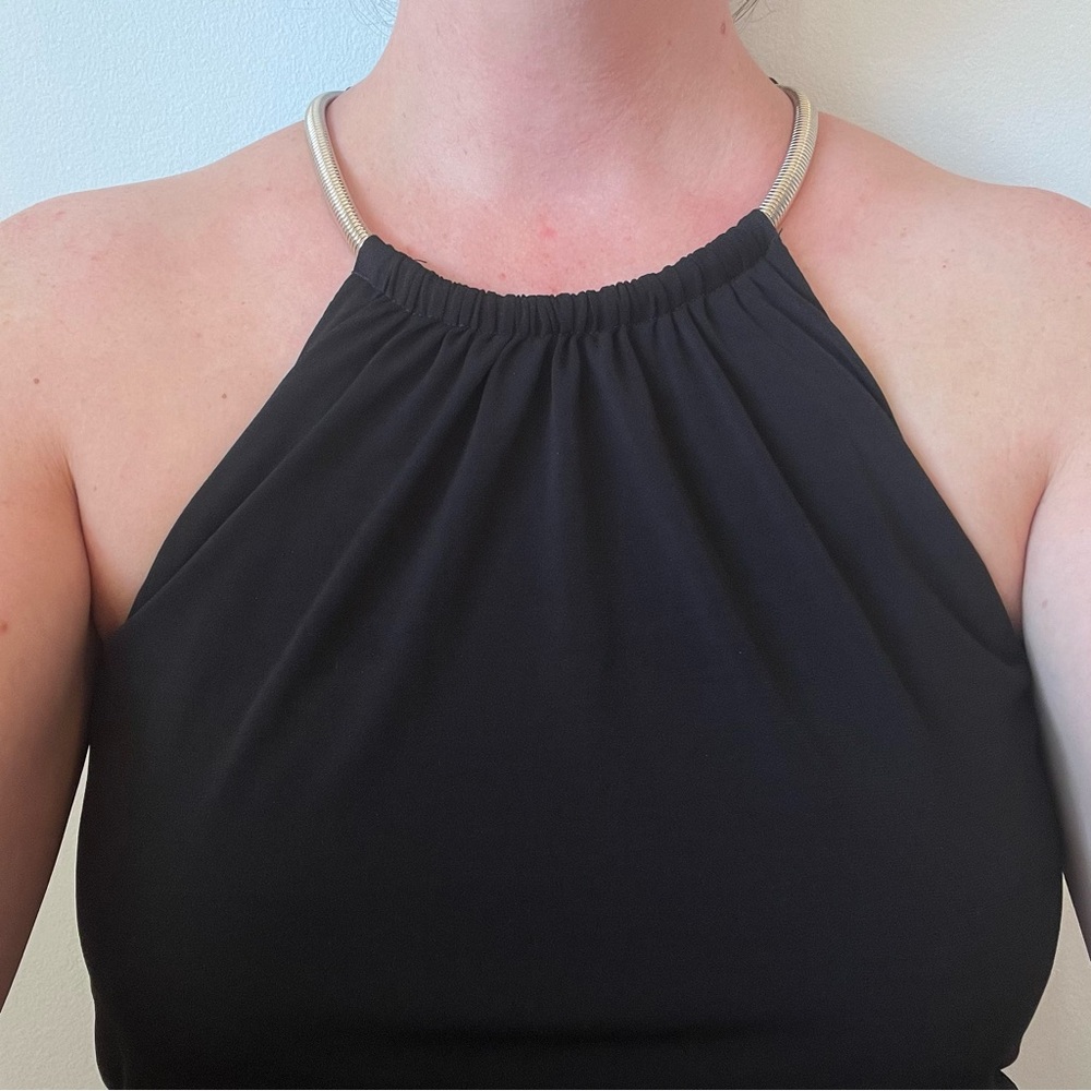 Black jumpsuit with gold neck chain